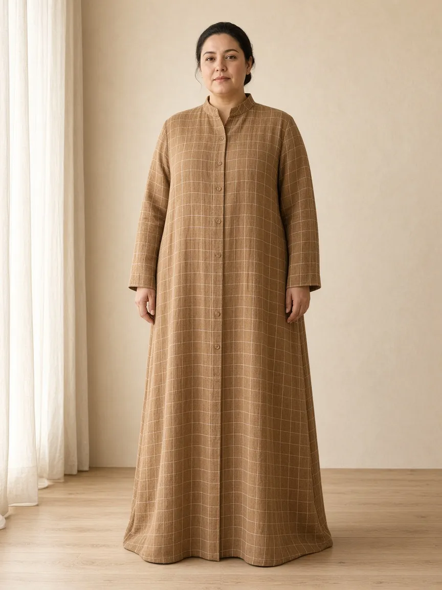 Studio photograph of a model wearing the Camel Check Linen Duster: floor length, long sleeves to the wrist, stand collar, buttoned through
