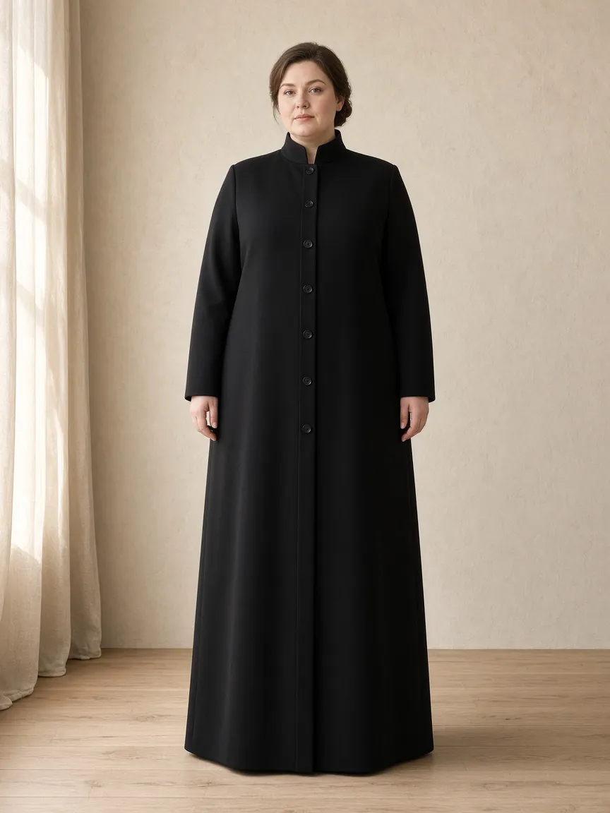 Studio photograph of a model wearing the Ink Ponte Duster: floor length, long sleeves to the wrist, stand collar, buttoned through